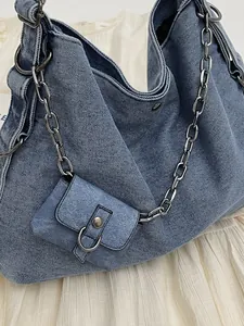 Large denim tote bag in washed blue with chunky silver chain and mini decorative pouch