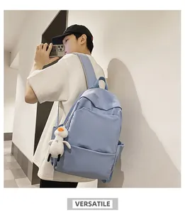 Detailed side view of light blue waterproof backpack with cute plush duck accessory