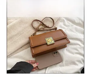 Brown crossbody bag size comparison with a smartphone showing dimensions and texture