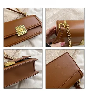 Detail shot of brown leather bag featuring golden lock and elegant chain strap