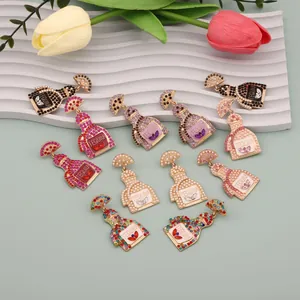 Detailed view of colorful Tequila bottle earrings with rhinestones and faux pearls