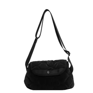 Black quilted puffer crossbody bag with cloud texture and adjustable shoulder strap