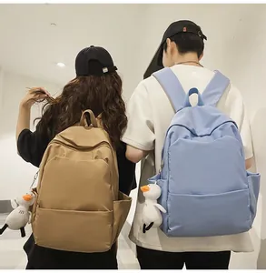 Detailed back view of khaki and blue waterproof backpacks with duck plush charms