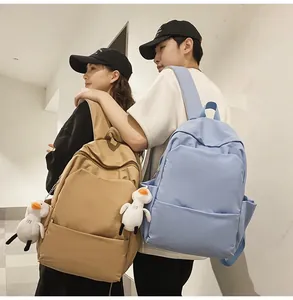 Close-up of minimalist waterproof backpack showing khaki and light blue color options