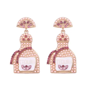 Fashionable Tequila bottle drop earrings with pink rhinestones and lemon slice charms