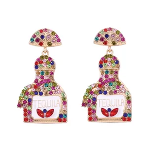 Close-up of Tequila bottle earrings with colorful rhinestones on a gold alloy base