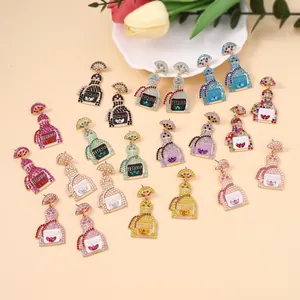 Close-up of diverse rhinestone Tequila bottle earrings in multiple vibrant colors