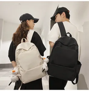 Detail view of large capacity waterproof backpacks in black and cream white with duck charms