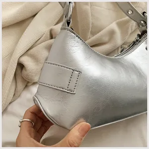 Close-up of the silver metallic hobo bag with adjustable strap and textured finish
