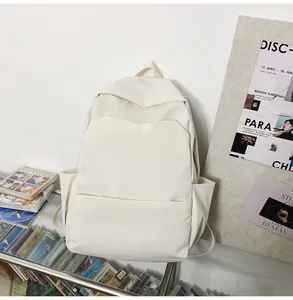 Minimalist cream waterproof backpack featuring multiple pockets in an artistic studio setting