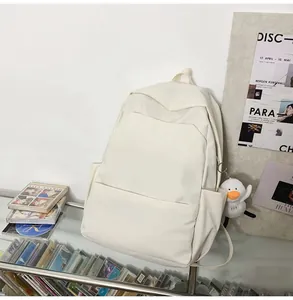 Off-white minimalist waterproof backpack with a plush duck pendant for daily use