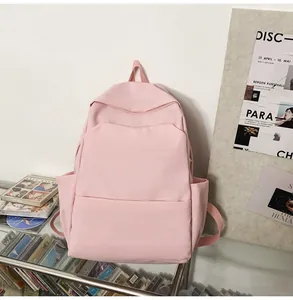 Pink minimalist waterproof backpack featuring side pockets and a durable nylon texture