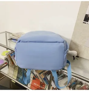 Detailed side view of light blue waterproof backpack showing large capacity base