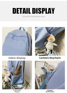 Detail view of light blue waterproof backpack with plush duck charm and reinforced stitching