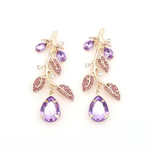 Elegant gold branch earrings with purple crystals and sparkling teardrop pendants