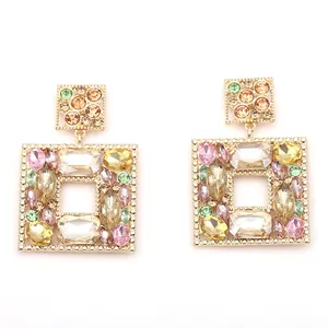 Detailed close-up of geometric gold alloy earrings with multicolored faceted crystals