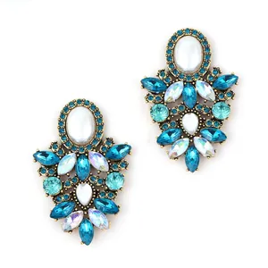 Vintage gold-tone chandelier earrings with blue rhinestones and white oval gemstones