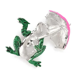 Verspielte Frosch-Brosche mit rosa Schirm aus Emaille und silberner Legierung