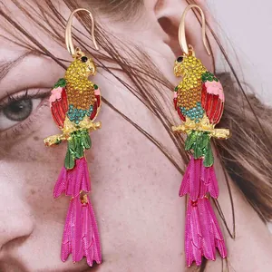 Exaggerated parrot drop earrings with colorful crystals and magenta feather charms