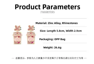 Detailed view of pink pumpkin spice cup earrings with rhinestones and butterfly charm