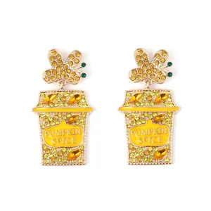 Golden earrings with yellow rhinestone butterflies and pumpkin spice latte cup charms