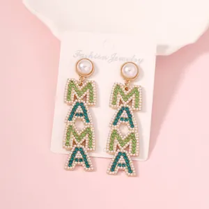Detail of MAMA letter earrings with blue and green rhinestones and faux pearls