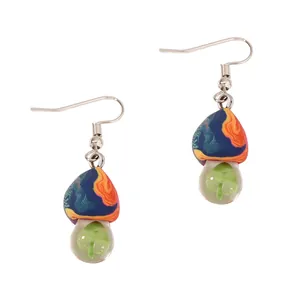 Handmade clay mushroom earrings with colorful marbling and transparent floral charms