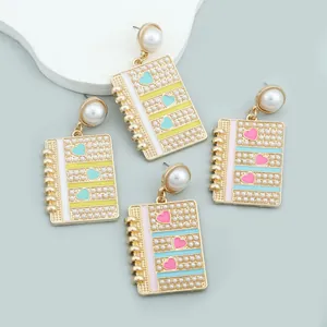 Creative notebook drop earrings with pearls and colorful enamel hearts in gold finish
