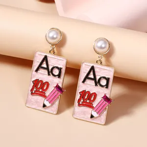 Pink school theme enamel drop earrings with letter Aa, number 100, and pencil detail