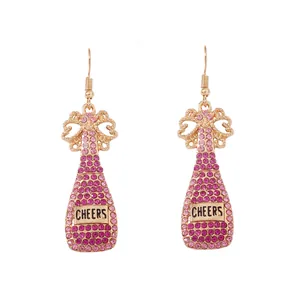 Pink rhinestone champagne bottle drop earrings with Cheers metal label and gold bow detail