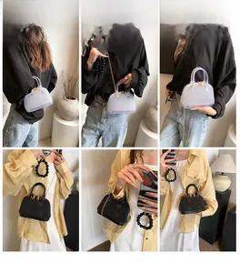 Model wearing jelly shell bags in transparent white and black with gold chains