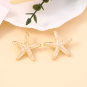 Elegant gold-edged starfish earrings with pearl white enamel and fine golden beads