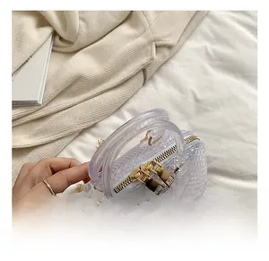 Close-up of transparent jelly bag with geometric texture and gold zipper detail