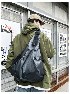 Detail of black waterproof crossbody bag with bungee cords and industrial buckles