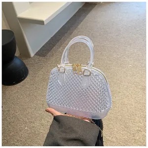 Detailed view of mini jelly bag with textured PVC finish and gold metal hardware
