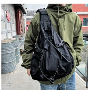 Tactical black crossbody bag featuring adjustable elastic cords and mesh side pocket