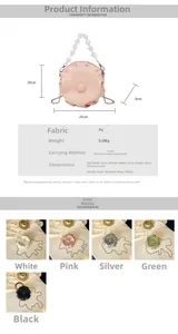 Detail of pink ruched cloud bag showing pearl handle, metal chain, and PU leather texture