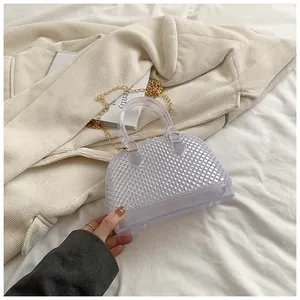 Detailed view of transparent jelly bag featuring diamond lattice texture and gold chain