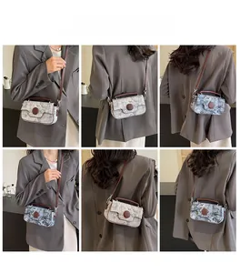 Detail view of retro floral crossbody bag with brown leather straps shown on model