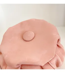 Close-up of pink flower-shaped leather handbag showing detailed petal stitching and texture