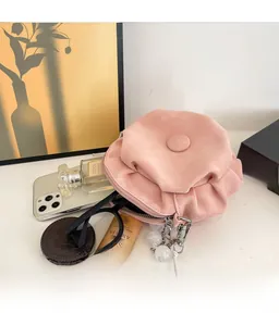 Inside view of pleated cloud bag showing storage for phone, glasses, and perfume