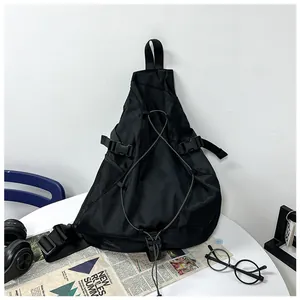 Close-up of black nylon crossbody bag with elastic drawstring and side mesh pocket