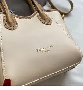 Close-up of contrast color bucket bag with premium lychee texture and fine stitching