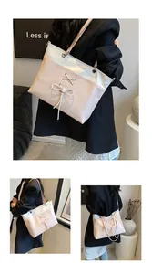 Detail of ballet style tote bag featuring a contrast bow design and metallic eyelet accents