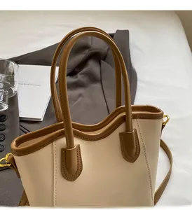 Close-up of minimalist beige tote bag with brown trim and comfortable round handle