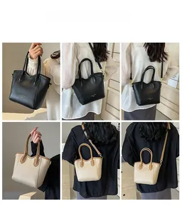 Detailed views of contrast-color leather tote bag with wavy rim and gold hardware