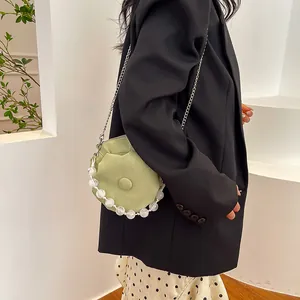 Chic light green cloud handbag with beaded handle and silver chain strap