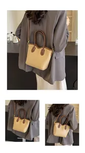 Detailed view of women's beige and brown bucket bag with Fashion & Classic lettering
