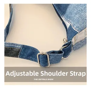 Detail of adjustable shoulder strap with metal buckle on blue denim patchwork bag
