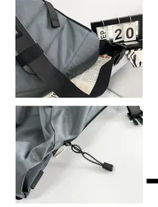 Detail of grey tactical crossbody bag with sturdy plastic buckle and nylon webbing strap